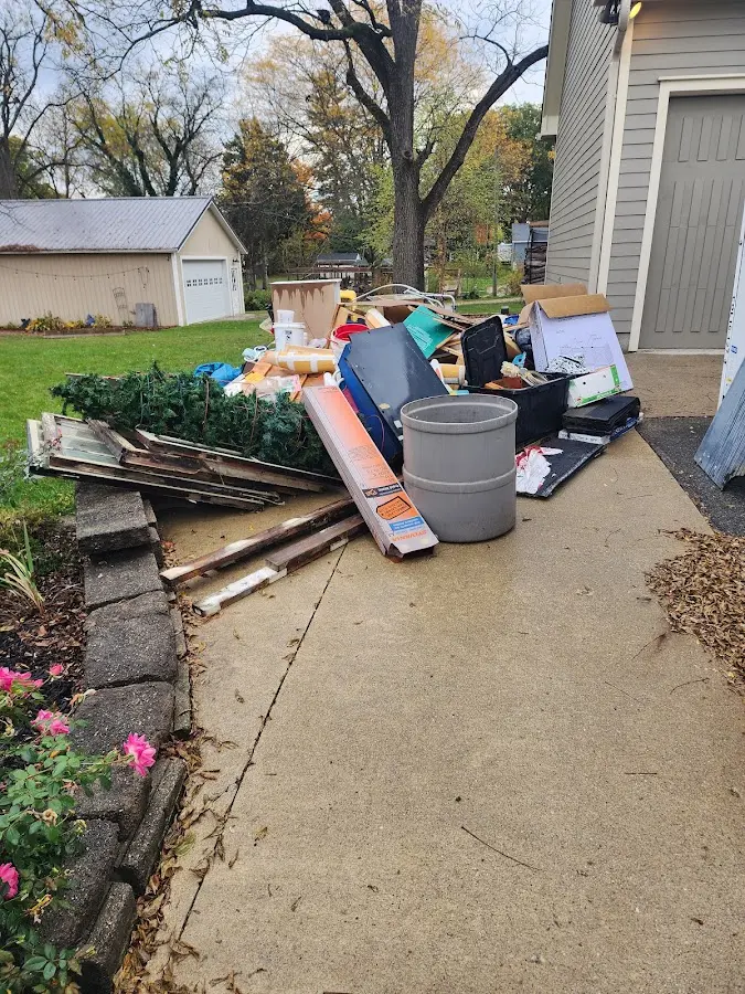 Dumpster being loaded with debris for Estate Cleanout Dumpster Rental in White